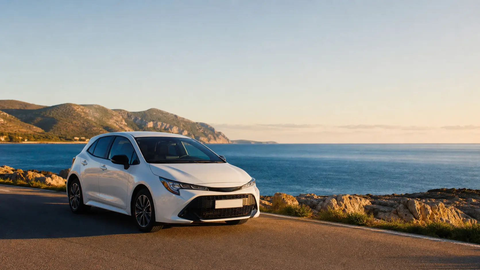 Rental car on a coastal road near Alghero in northwest Sardinia