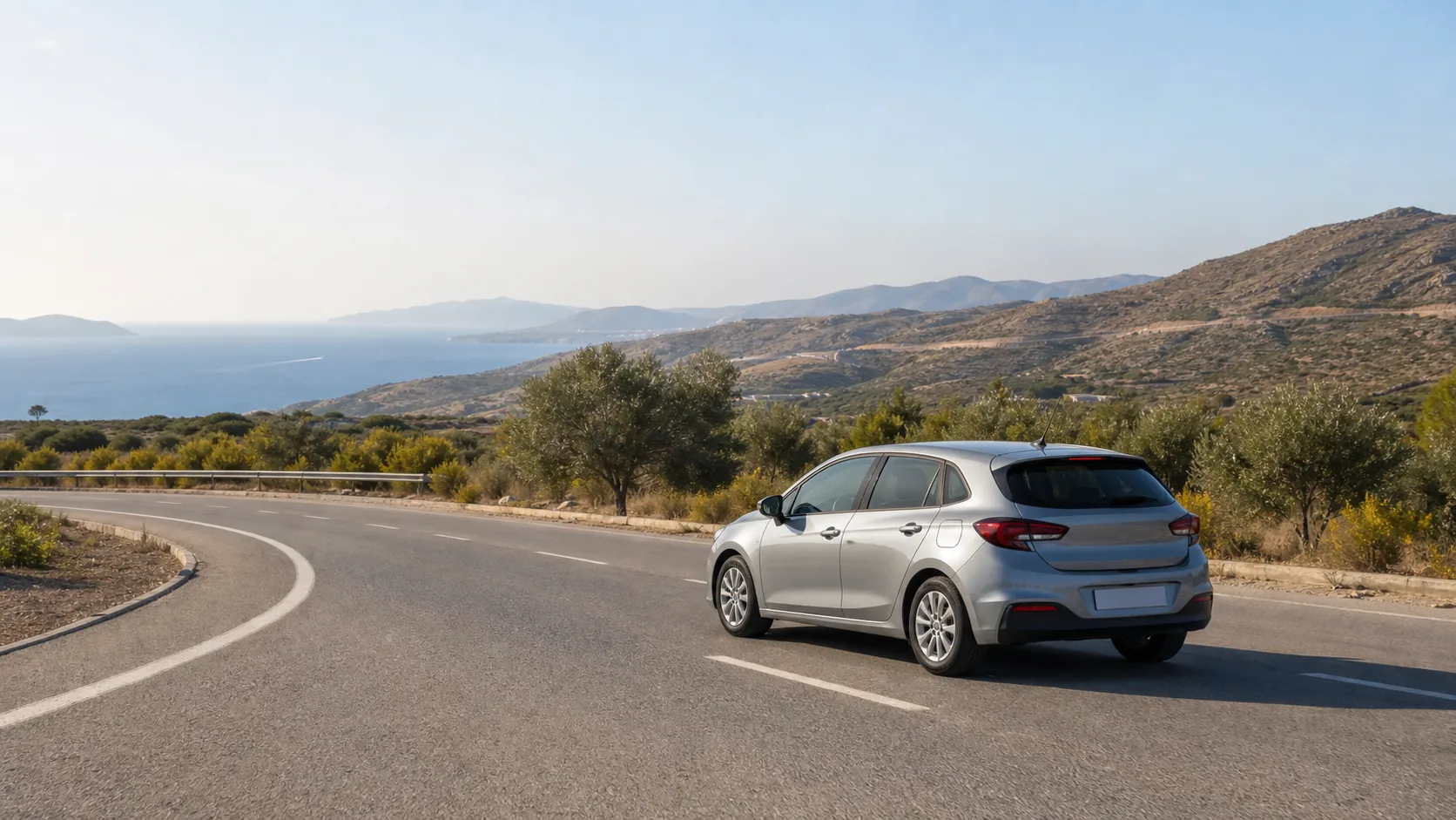 Illustrative rental car on a coastal Aegean road beside dry hills and olive trees