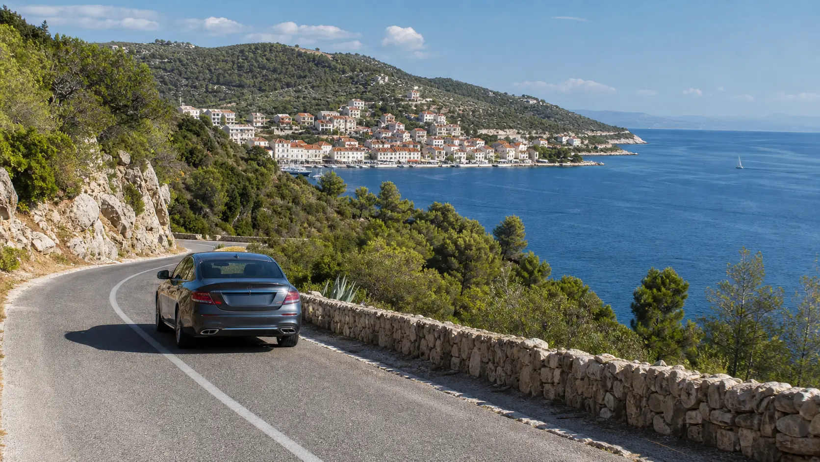 Rental car on a coastal road overlooking Hvar Island in Croatia