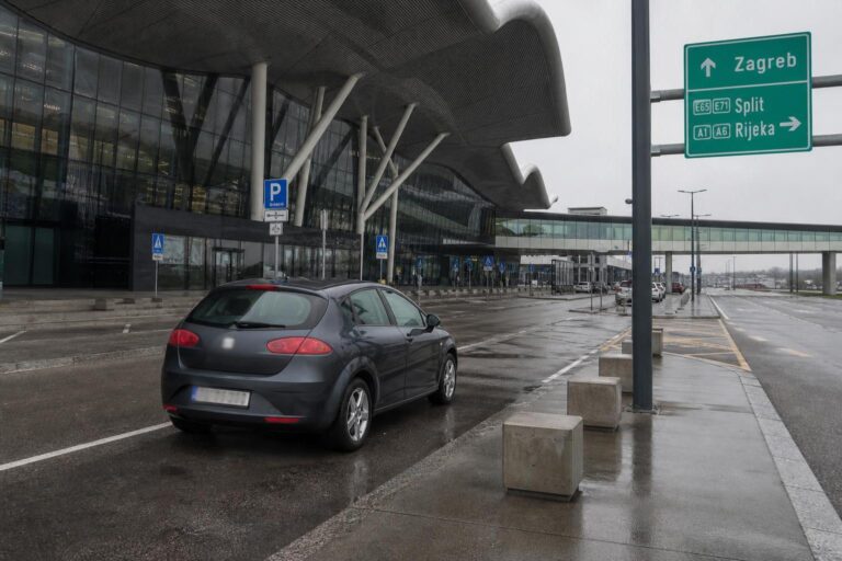 Rental car beside an airport terminal
