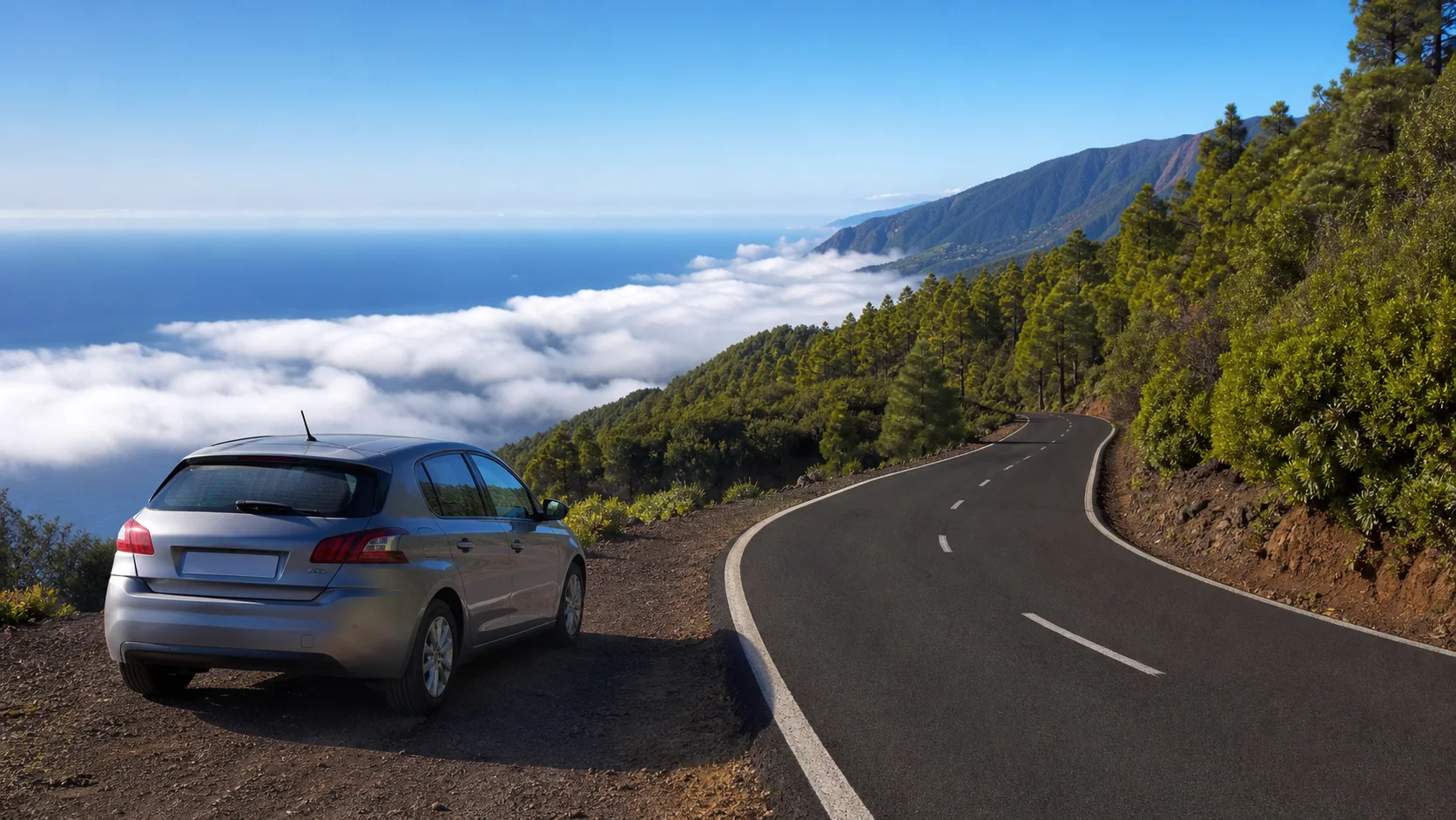 Illustrative rental car beside a winding volcanic road above the Atlantic on La Palma