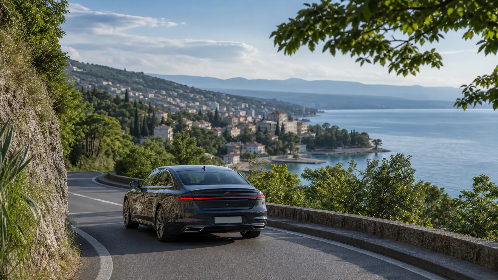 Rental car on a coastal road overlooking Opatija and the Kvarner coast