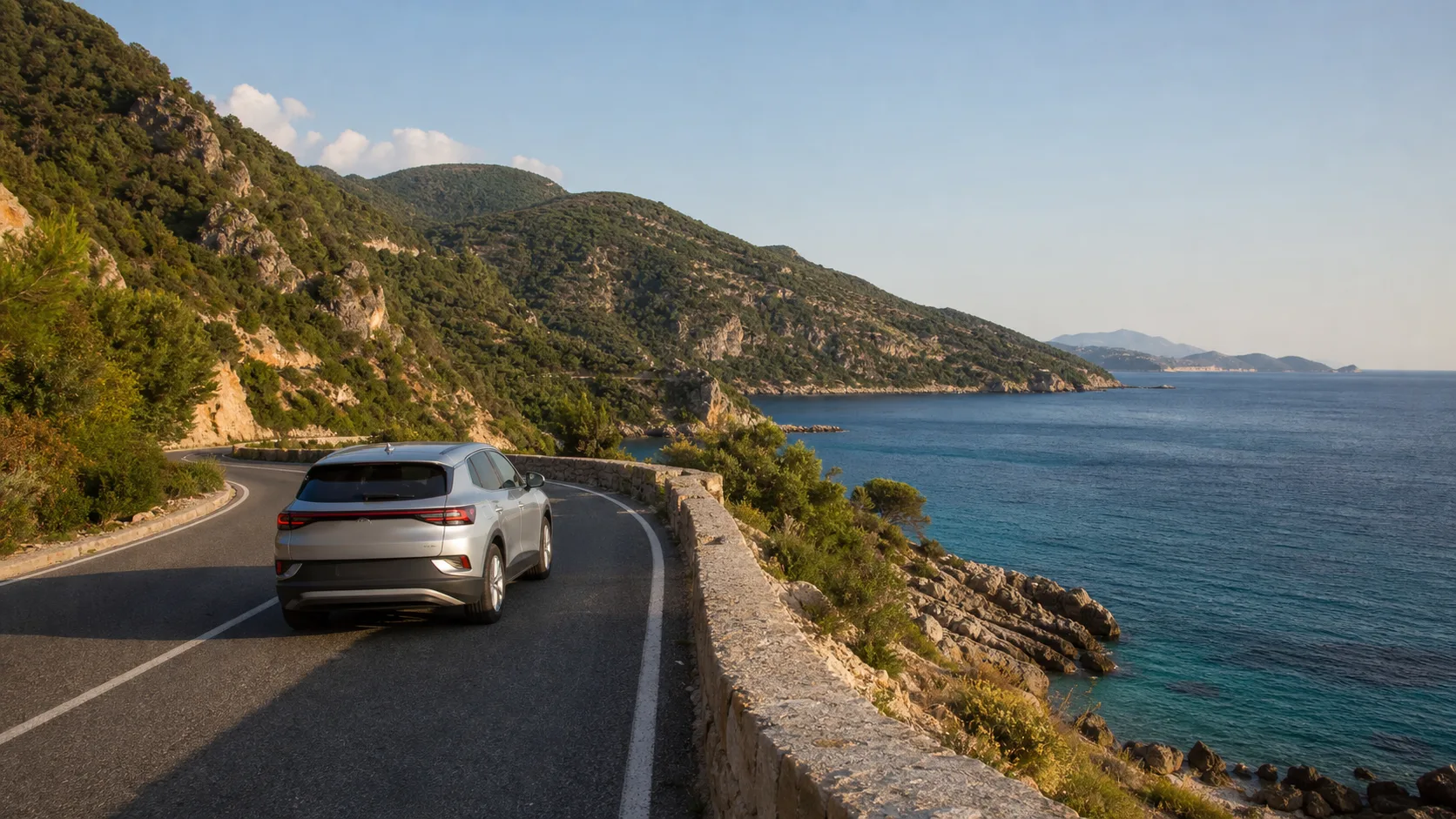 Rental car on an Adriatic coastal road near Petrovac in Montenegro