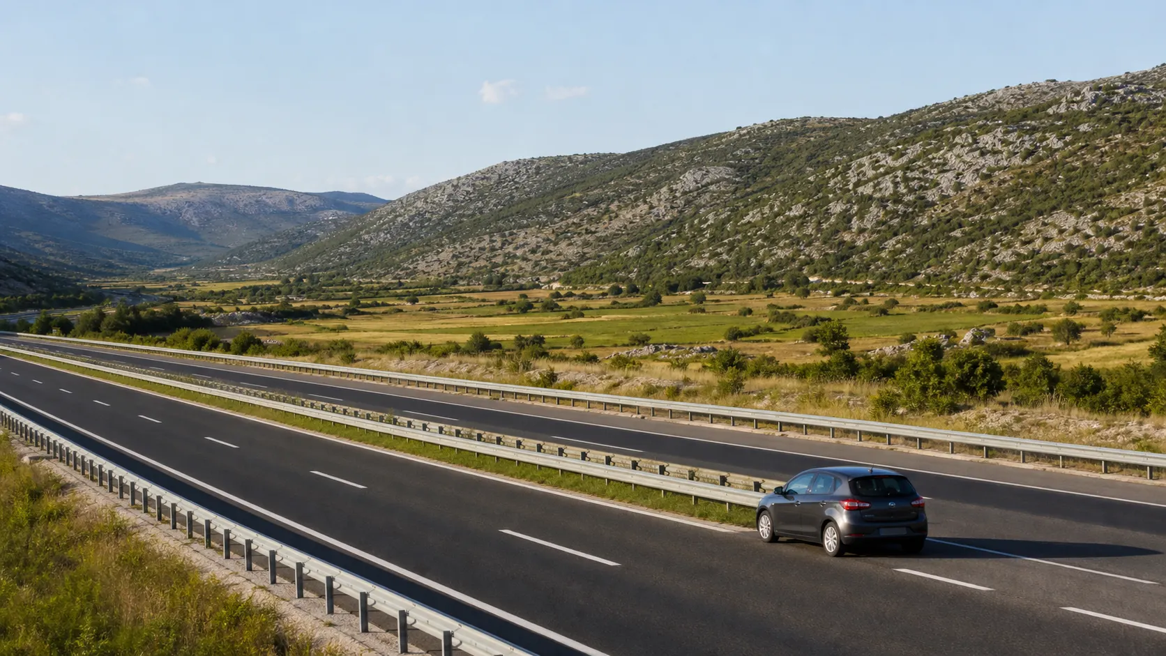 Rental car travelling on a Croatian motorway through a valley between Zagreb and Split
