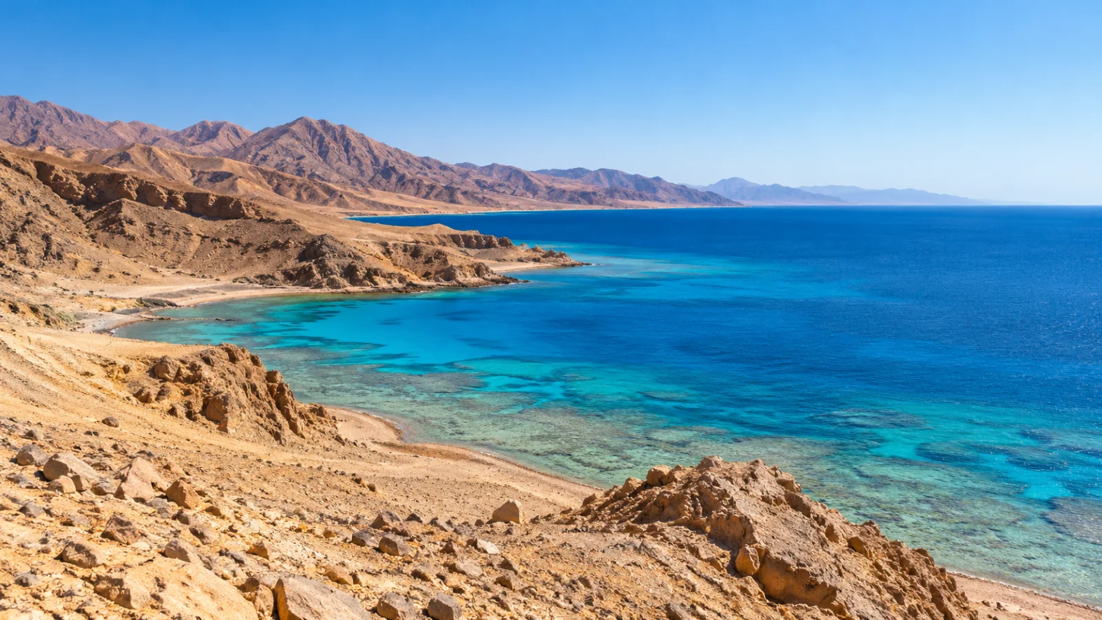 Desert hills above blue Red Sea shallows