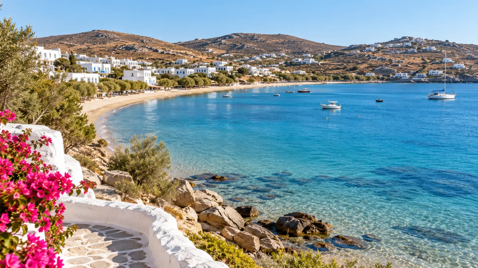 White hillside houses around a sheltered sandy bay