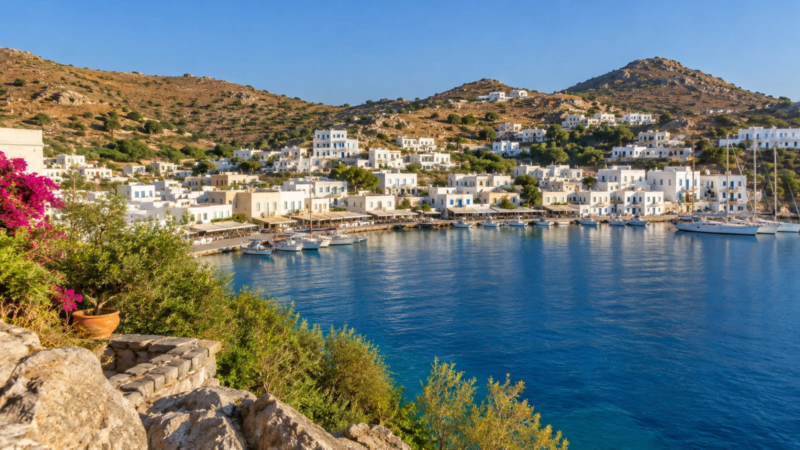 White houses and boats around a sheltered dry-hill harbour